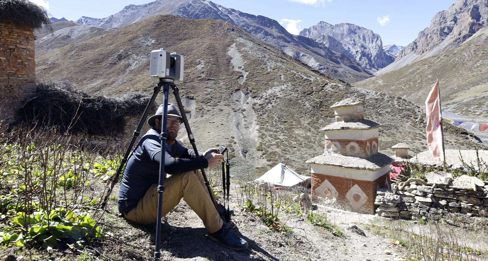 Peter Bauer rests under the tripod in Nepal, to avoid being part of the point cloud – Source Peter Bauer